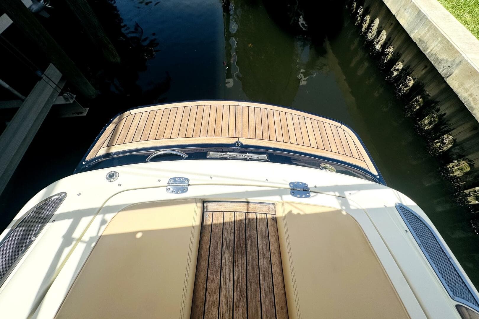 2013 Chris-Craft Corsair 22 boat with teak deck, docked in calm water.
