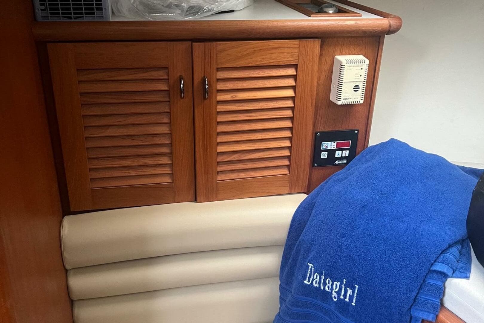 2001 Pursuit 3000 Offshore cabin with wooden cabinets and blue towel.