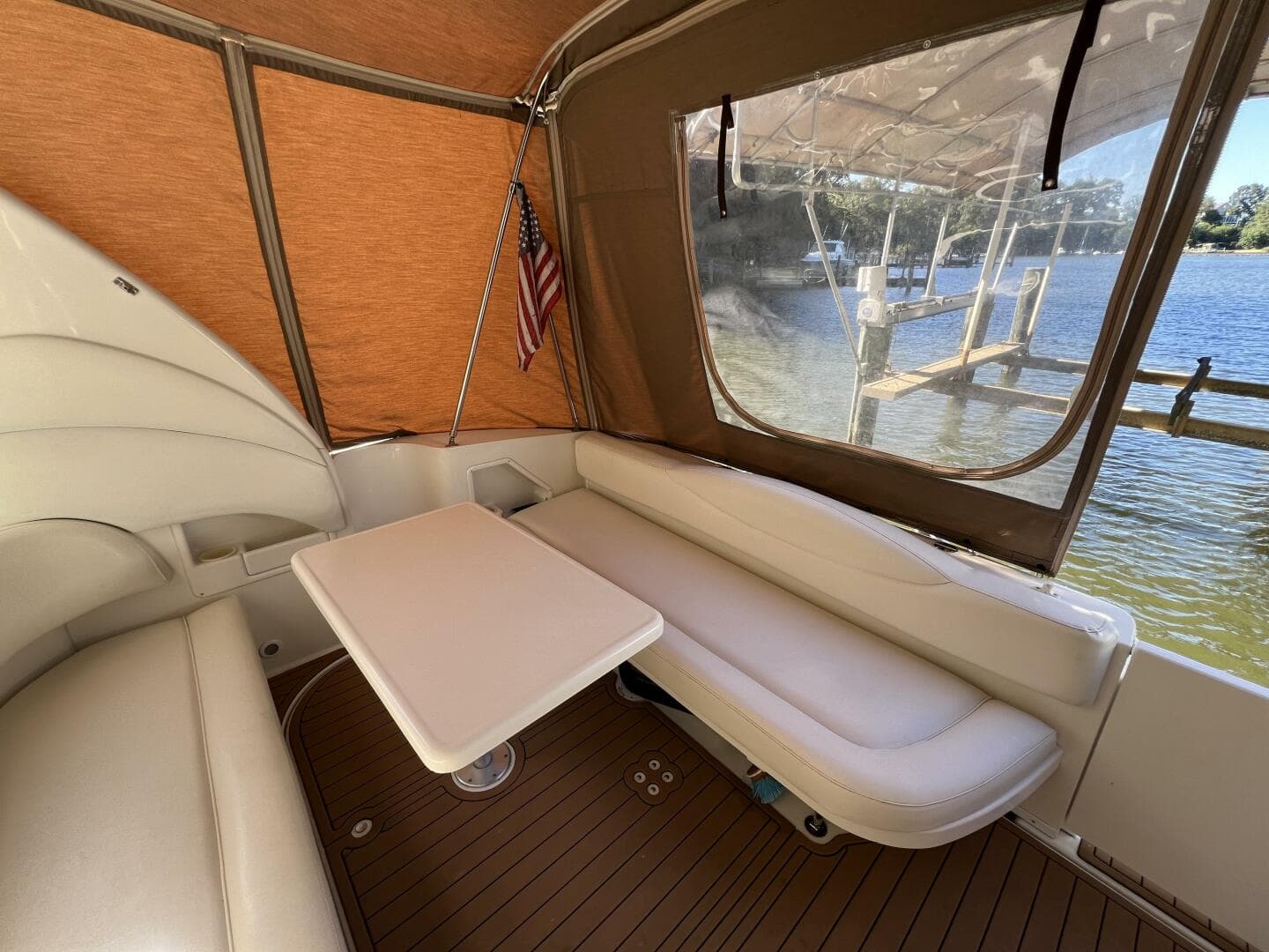 2002 Sea Ray 360 Sundancer Aft Seating with Removable table and Faux Teak SeaDek in the Cockpit looking aft
