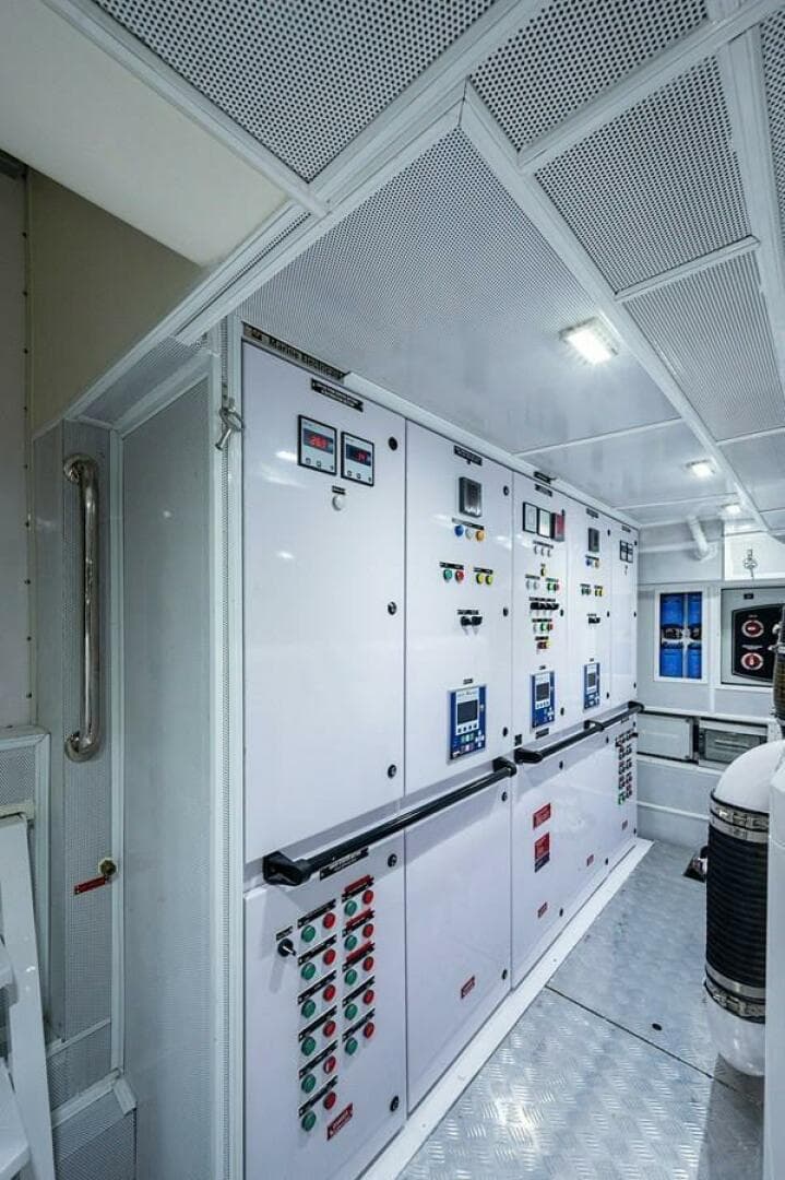 Engine room of 2020 Majesty 140 yacht with control panels and equipment.