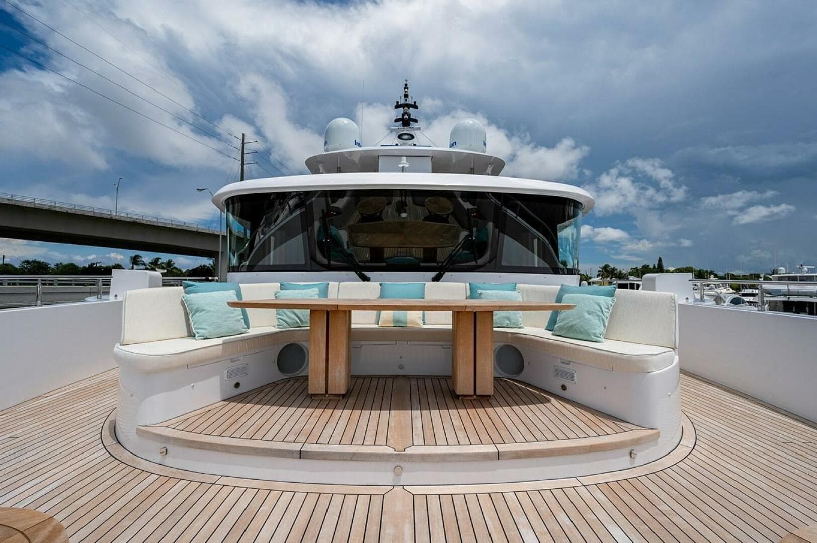 Luxurious 2020 Majesty 140 yacht deck with seating and table under cloudy sky.