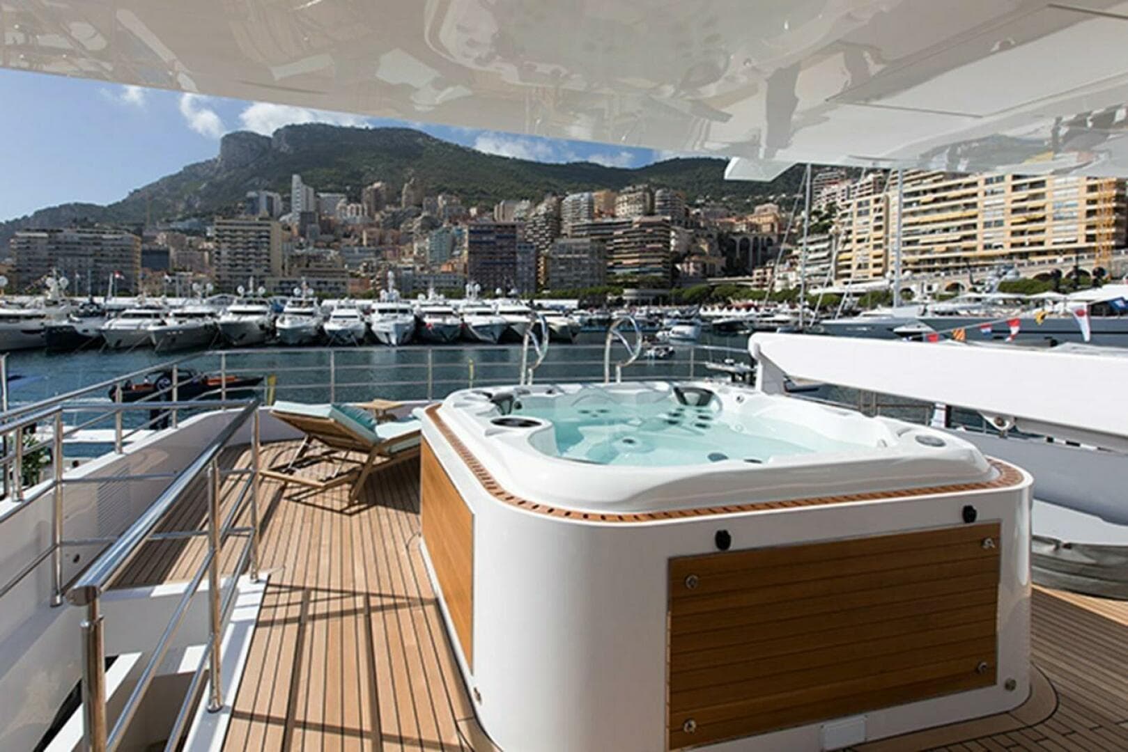 Luxury yacht Majesty 140 with jacuzzi, docked in a scenic marina, 2020 model.