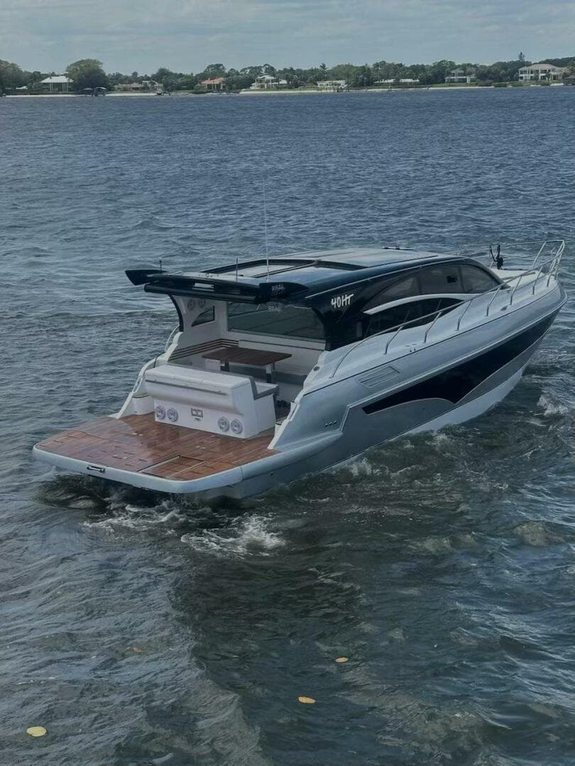 2025 Real 40 HT Luxury yacht cruising on a serene lake.