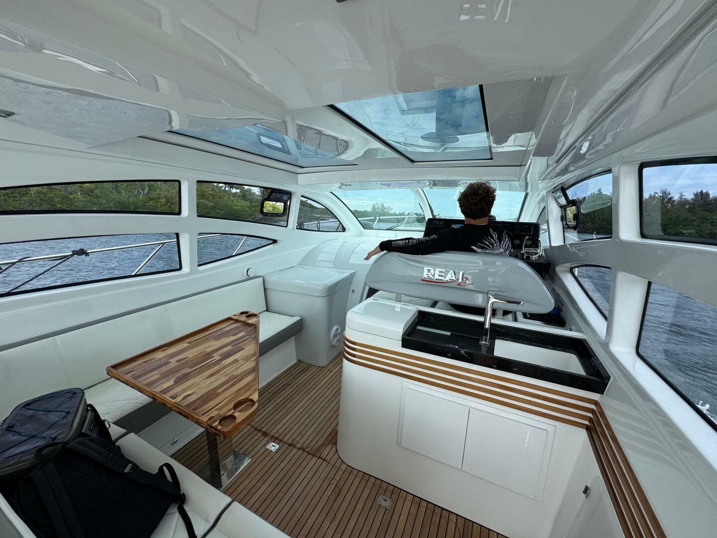 Luxurious interior of 2025 Real 40 HT yacht with modern design and panoramic windows.