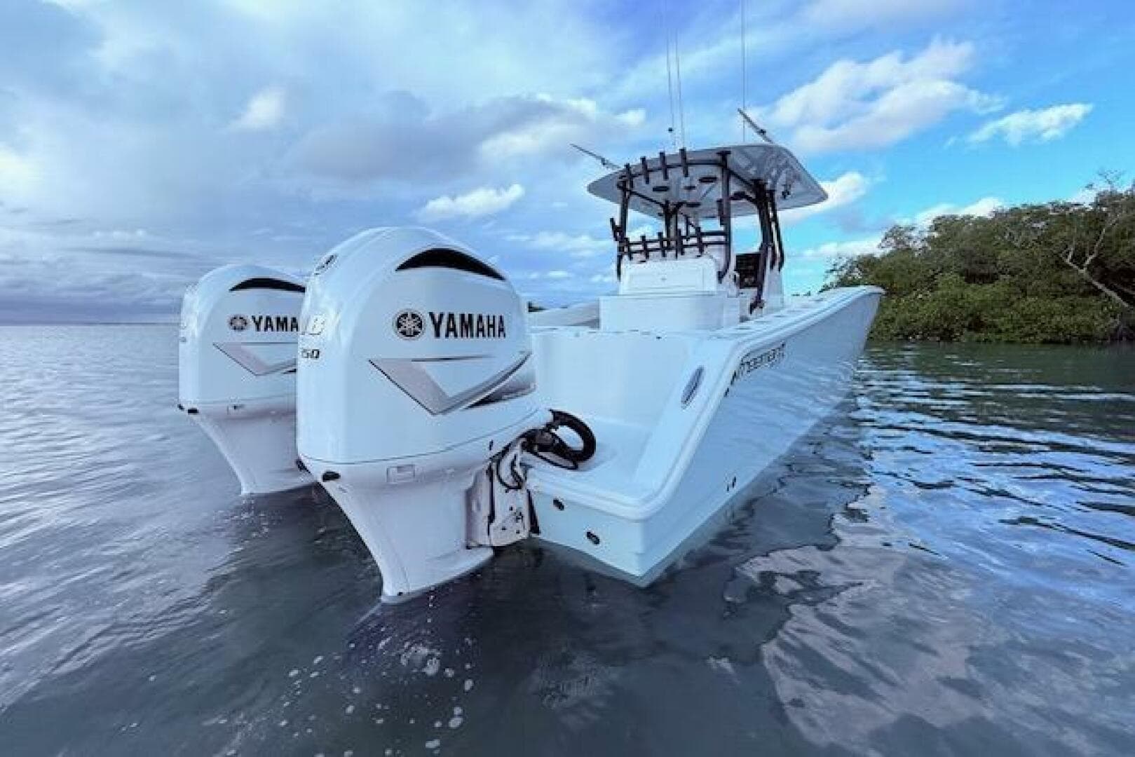 2019 Freeman 34 boat with twin Yamaha engines on calm water.
