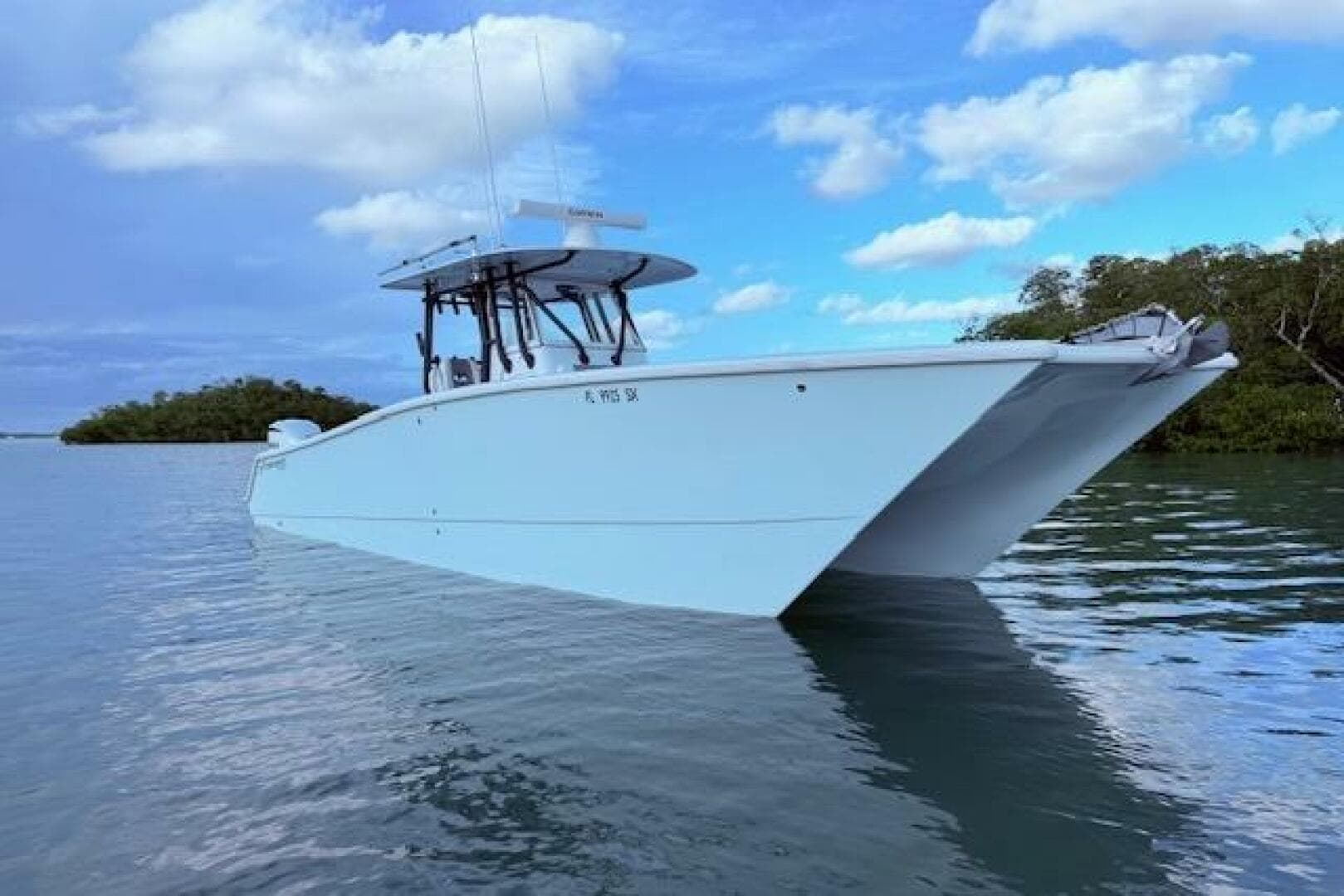 2019 Freeman 34 boat on calm water under a partly cloudy sky.