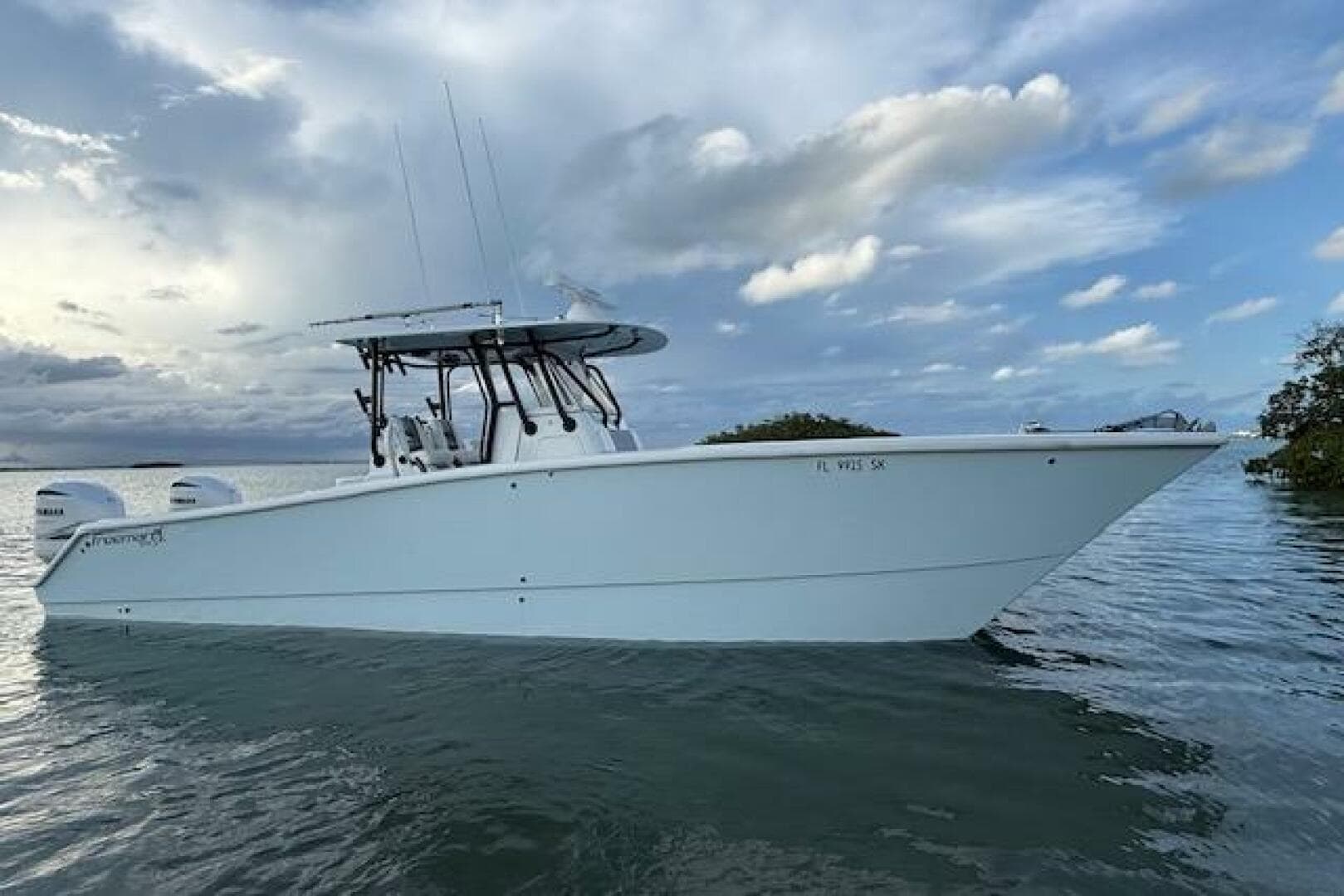 2019 Freeman 34 boat on calm water under cloudy sky.