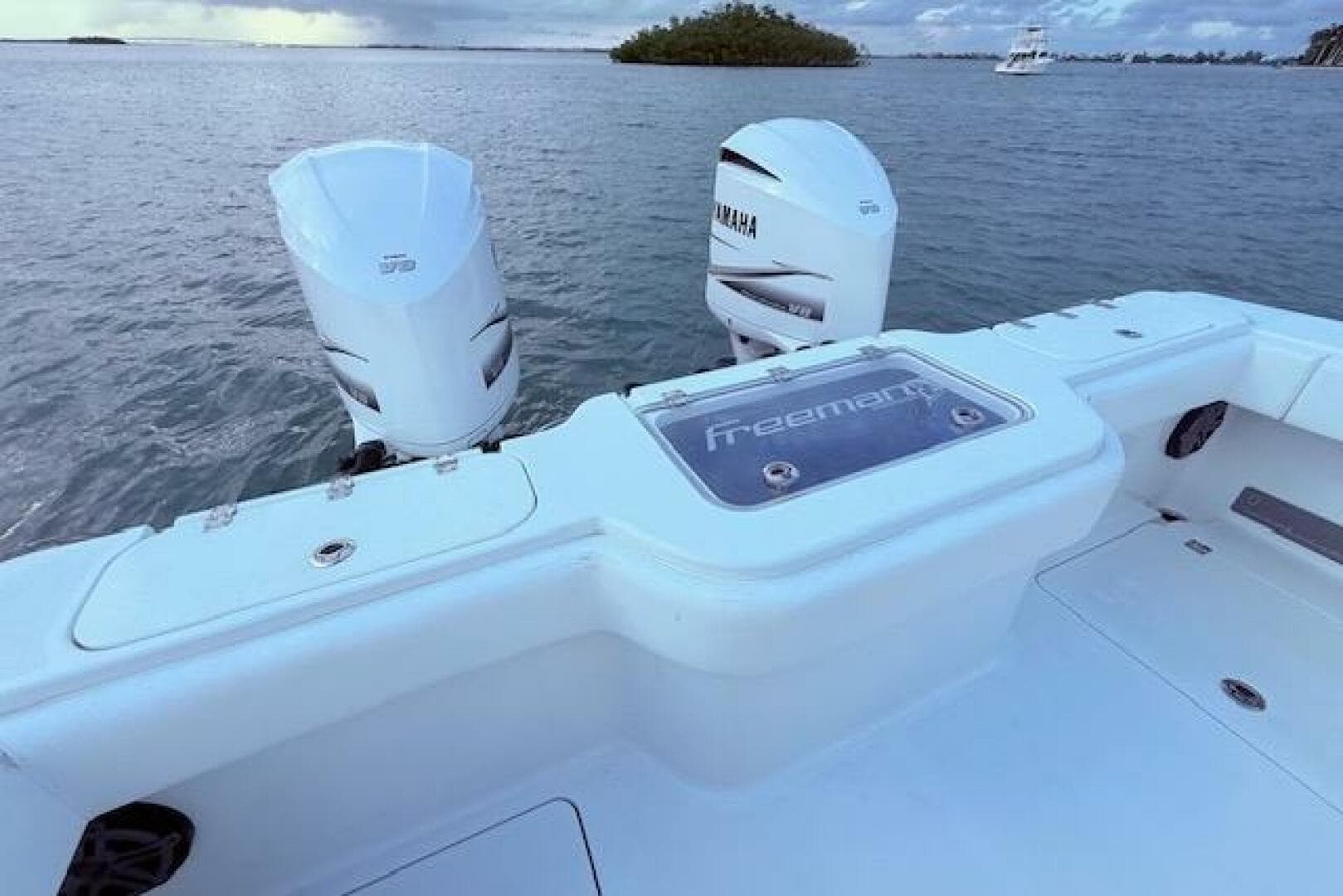 2019 Freeman 34 boat with Yamaha engines on calm water.
