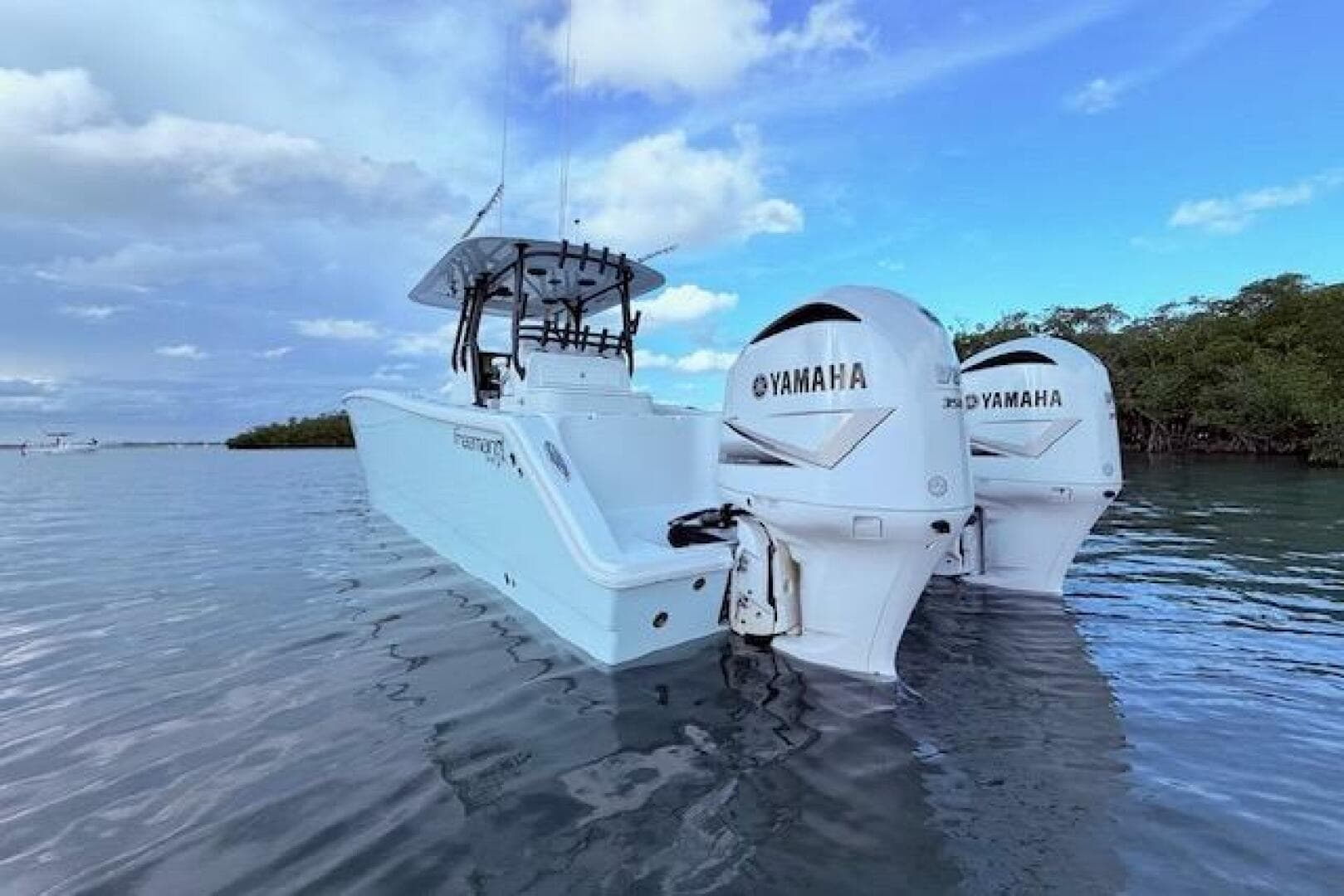 2019 Freeman 34 boat with twin Yamaha engines on calm water.