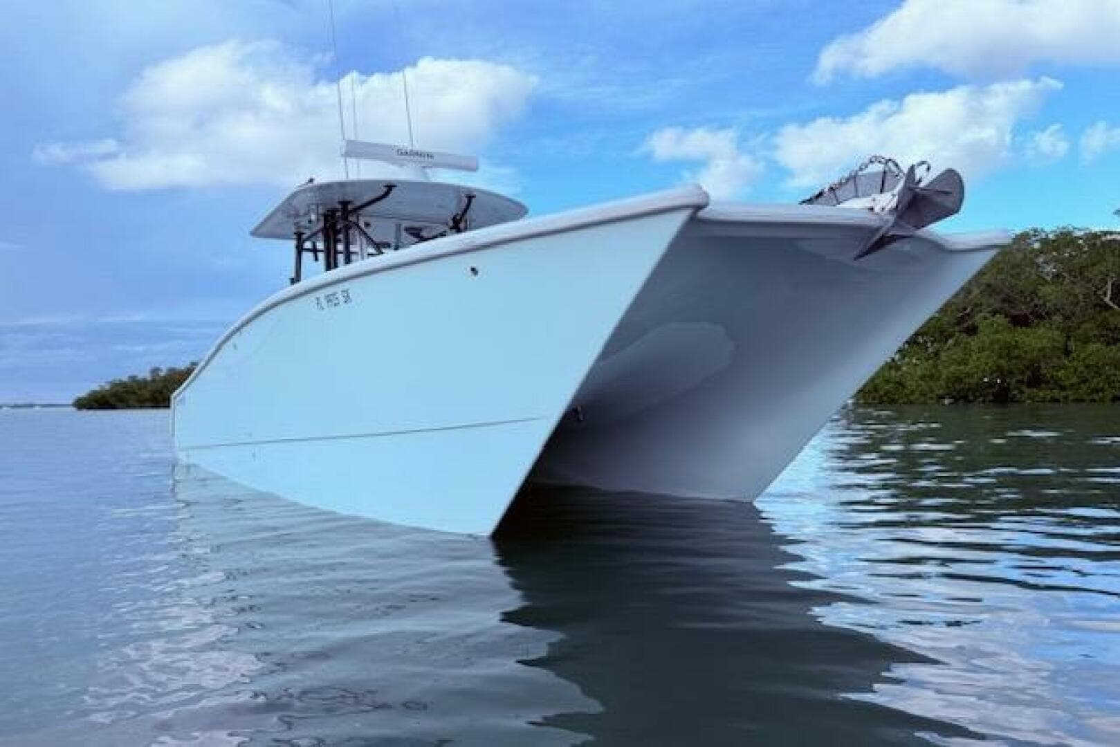 2019 Freeman 34 boat on calm water under a blue sky.