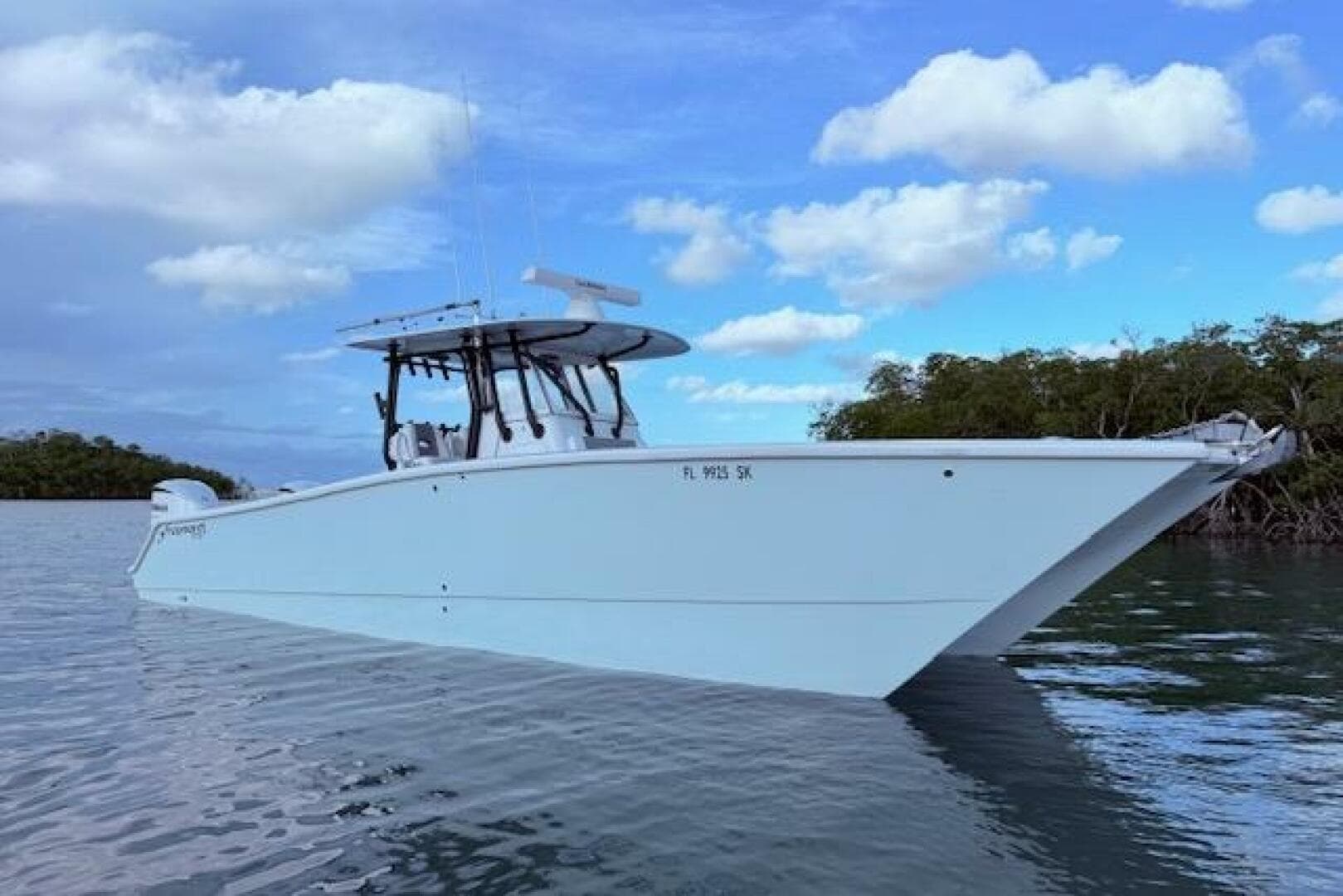 2019 Freeman 34 boat on calm water under a partly cloudy sky.