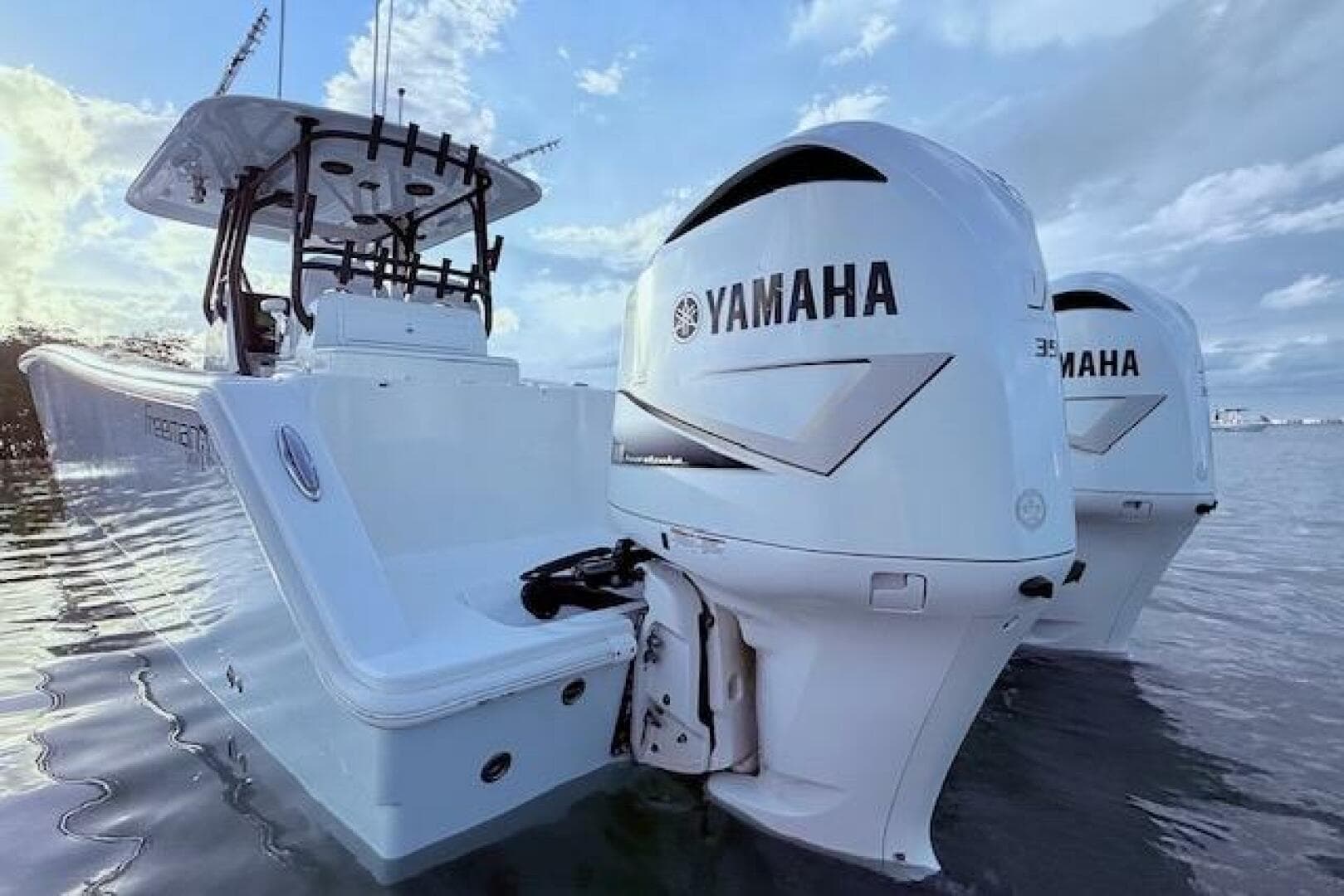 2019 Freeman 34 boat with twin Yamaha outboard engines on calm water.
