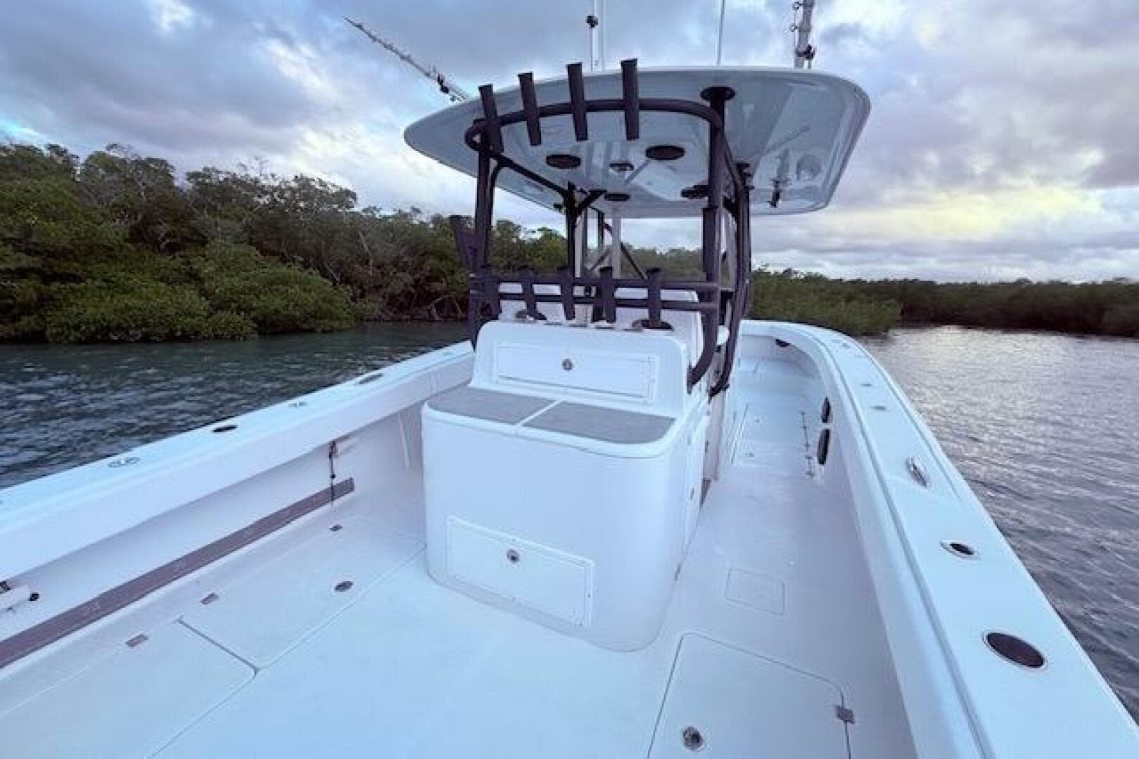 2019 Freeman 34 boat on calm water, surrounded by lush greenery.