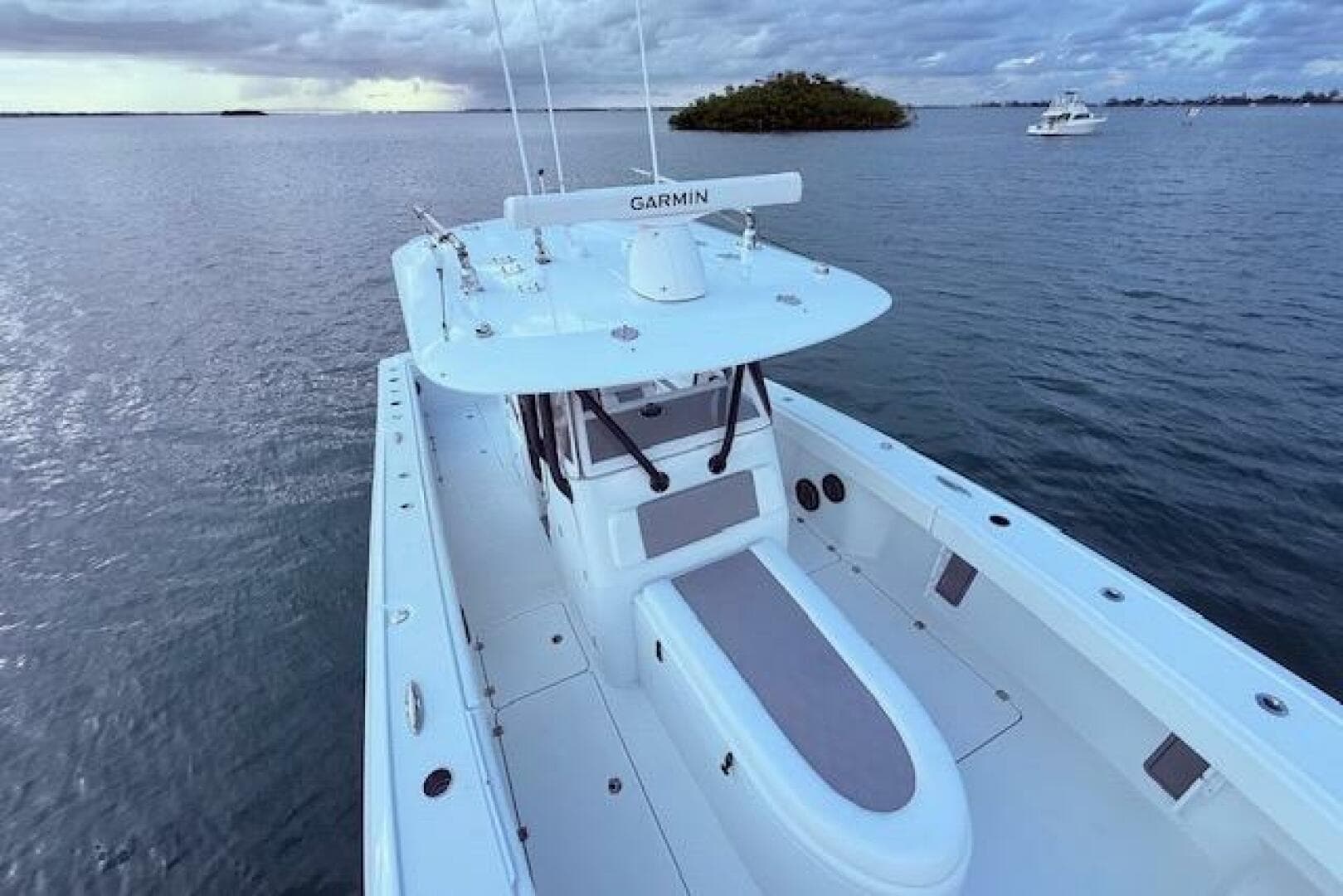 2019 Freeman 34 boat on calm water, featuring Garmin equipment, under a cloudy sky.