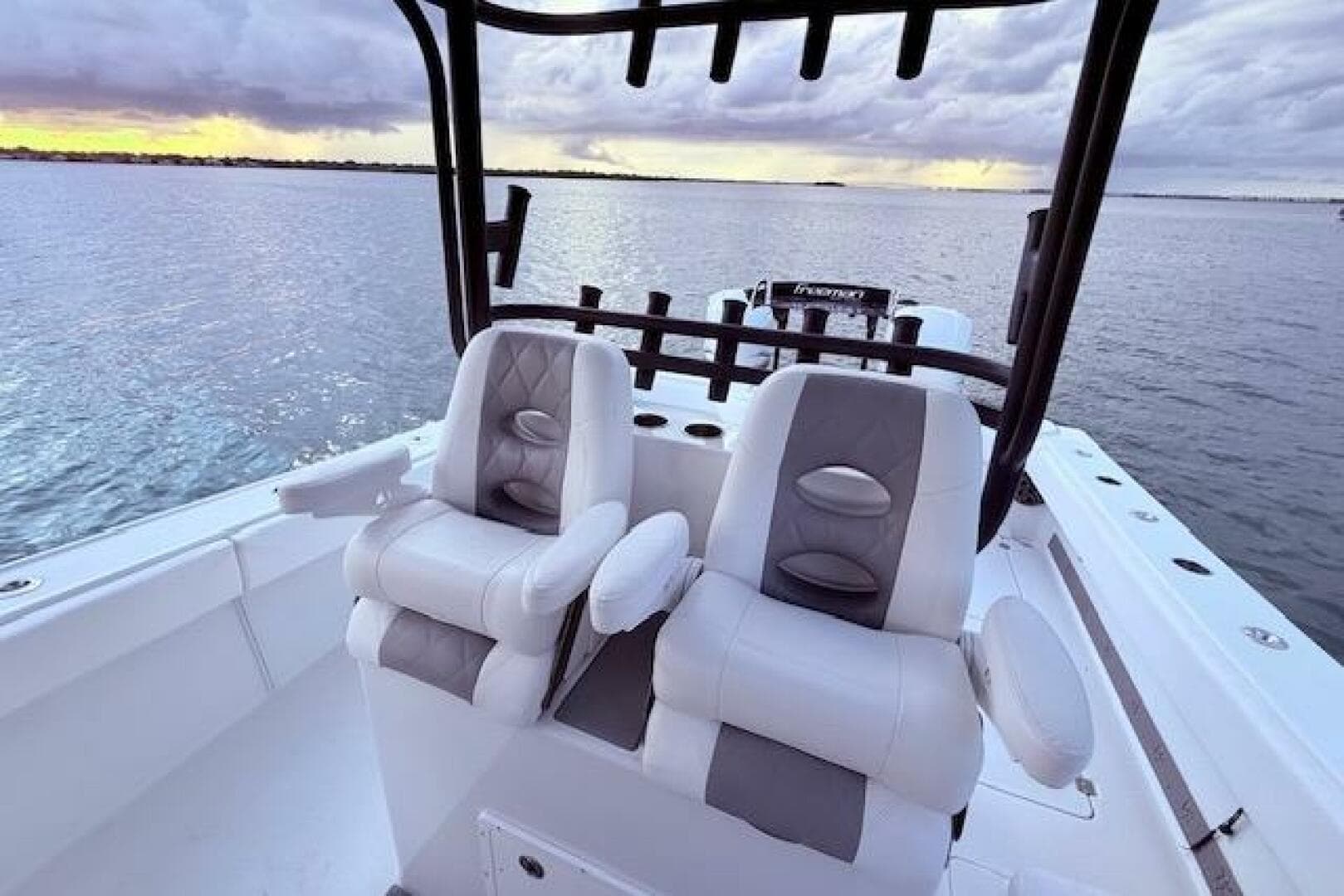 2019 Freeman 34 boat interior with dual seats, overlooking calm waters at sunset.