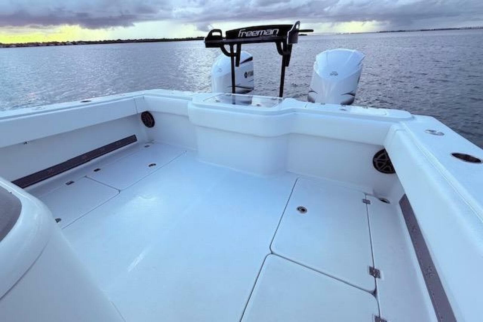 2019 Freeman 34 boat deck with dual engines on calm water.