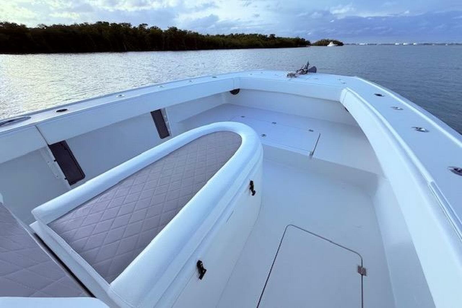 2019 Freeman 34 boat interior with cushioned seating, on calm water.