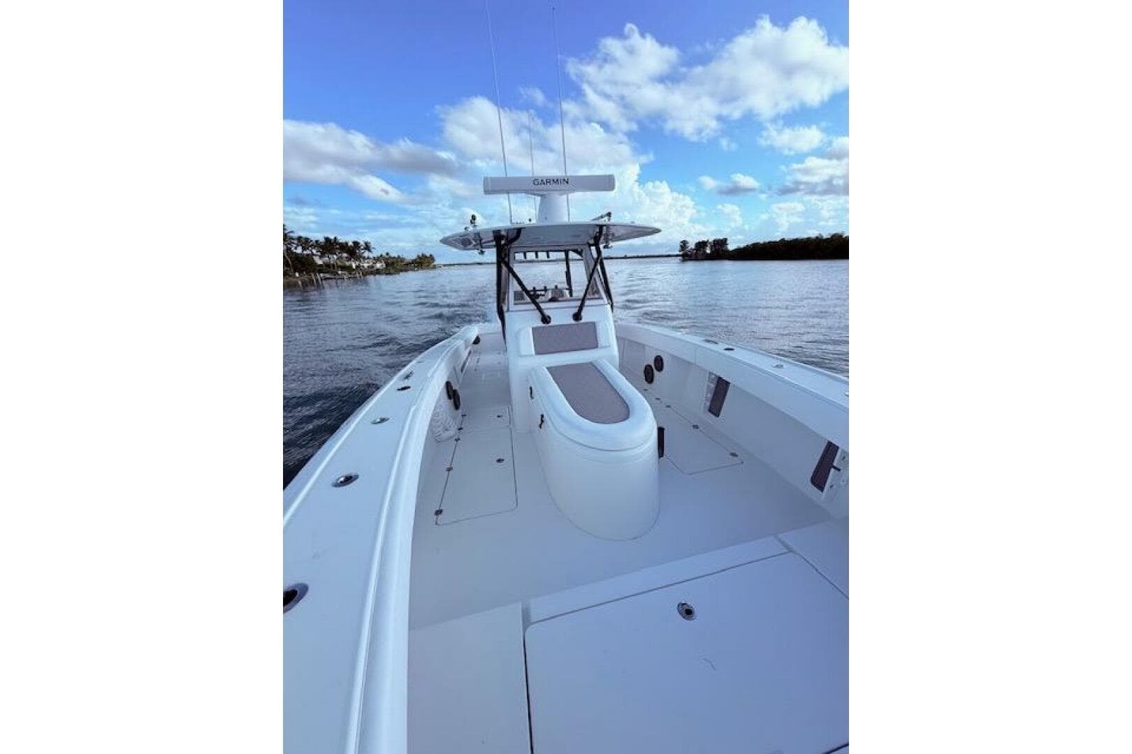 2019 Freeman 34 boat on calm water under a blue sky with clouds.