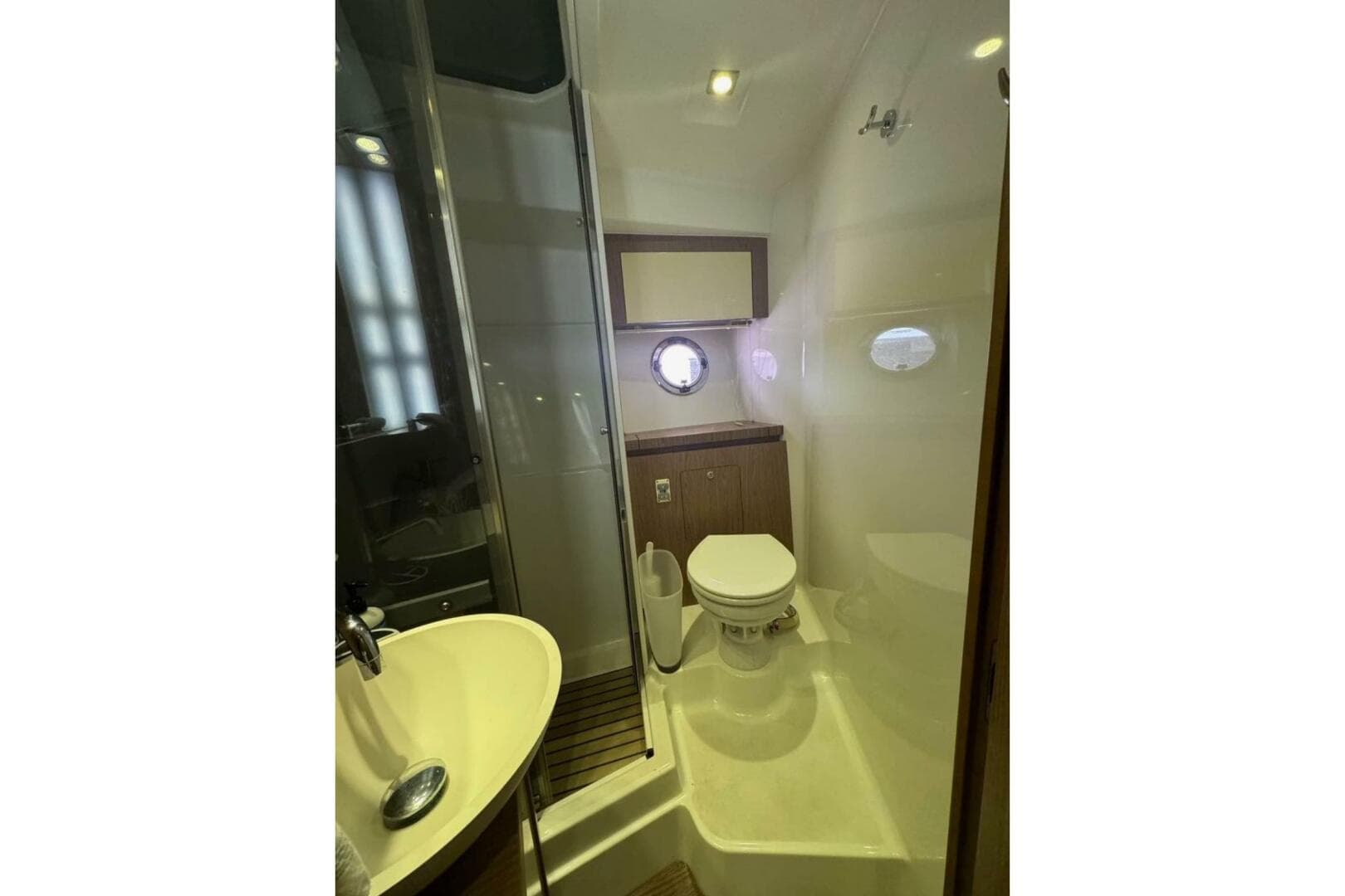 Bathroom interior of 2014 Beneteau Gran Turismo 44 yacht, featuring modern fixtures and porthole window.