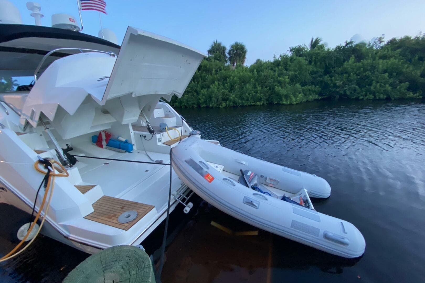 2014 Beneteau Gran Turismo 44 yacht with inflatable boat on calm water.