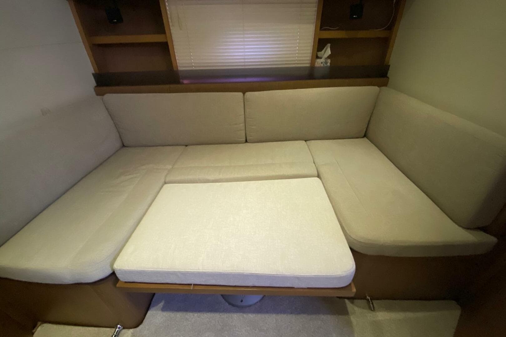 Interior seating area of 2014 Beneteau Gran Turismo 44 yacht with beige cushions.