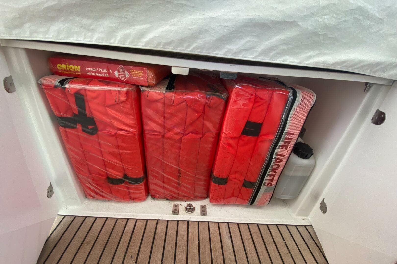Storage compartment with life jackets and marine signal kit on a 2014 Beneteau Gran Turismo 44.