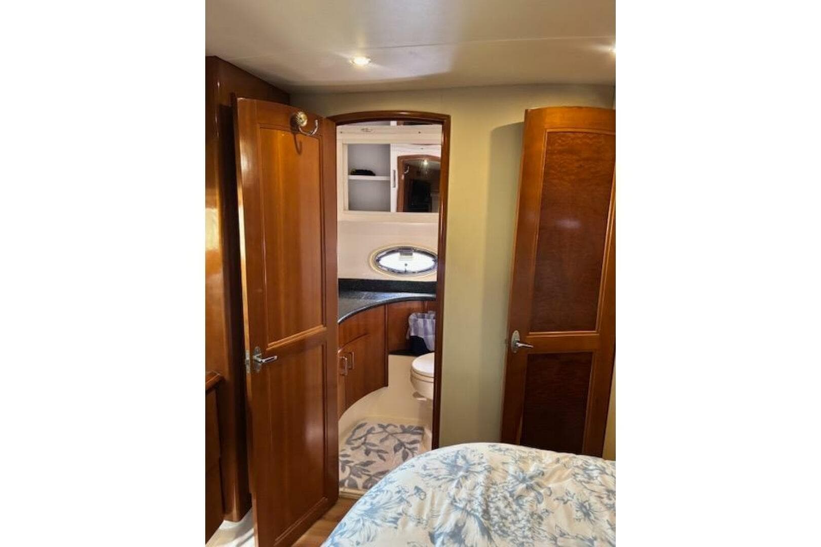 Interior of 2004 Carver 466 Motor Yacht with wooden cabinetry and bathroom view.