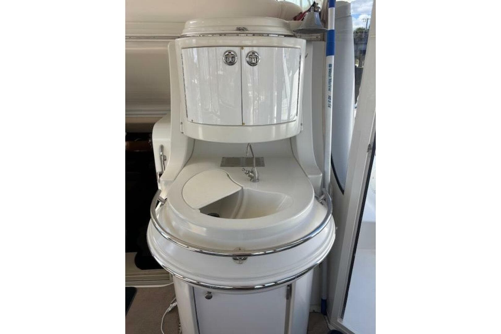 2004 Carver 466 Motor Yacht interior sink with storage cabinets.