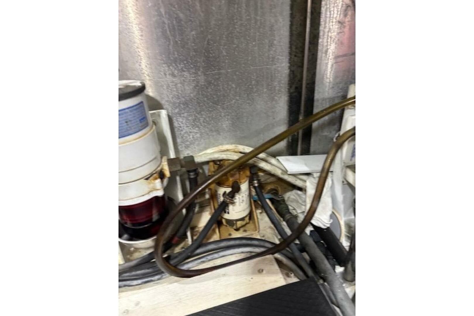 Engine room of 2004 Carver 466 Motor Yacht with visible fuel filter and hoses.