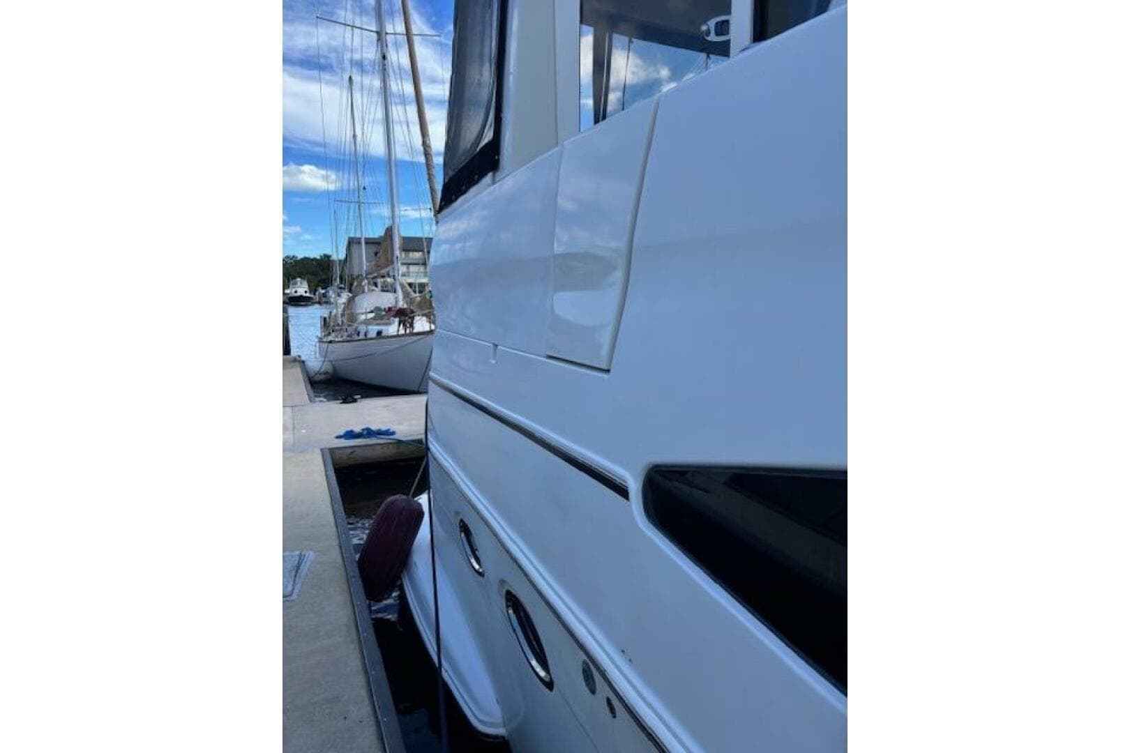 Side view of a 2004 Carver 466 Motor Yacht docked at a marina.