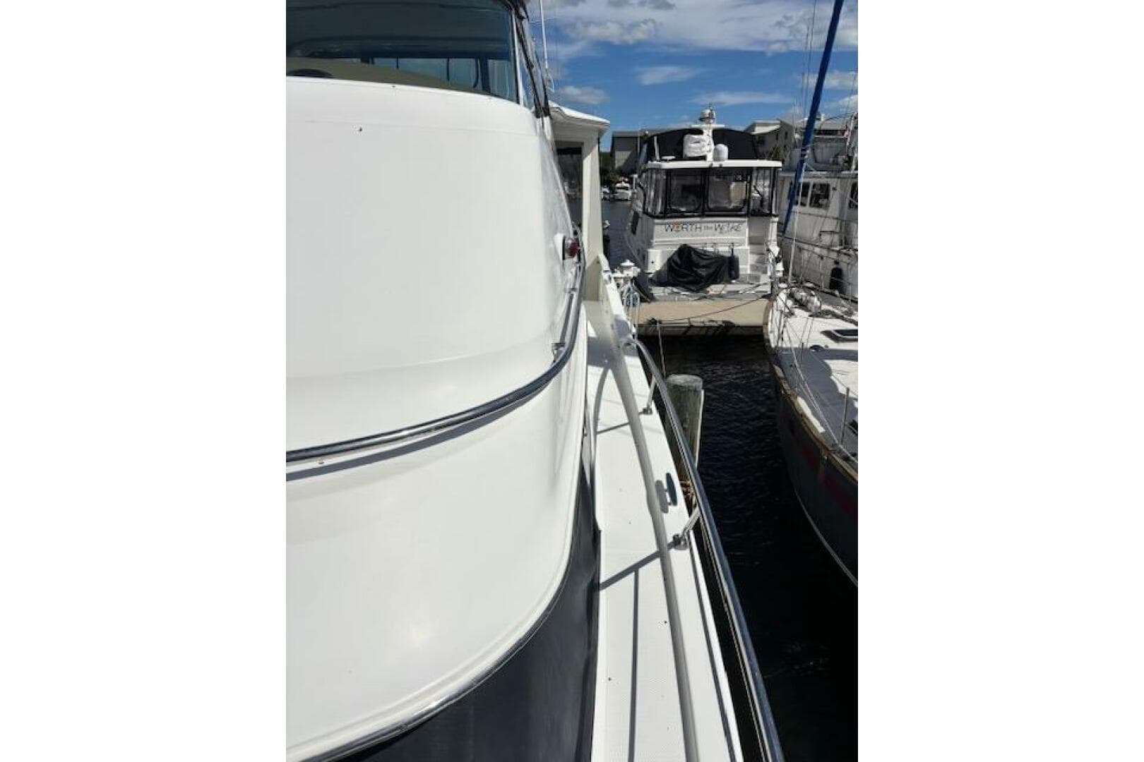 2004 Carver 466 Motor Yacht docked at marina, side view with clear sky.
