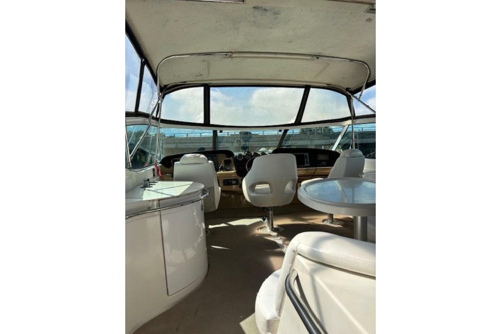 2004 Carver 466 Motor Yacht interior with helm, seating, and panoramic windows.