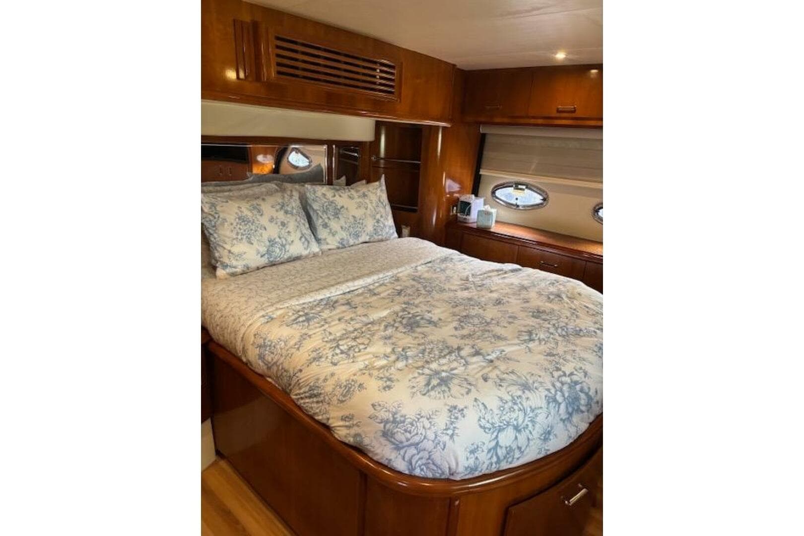 Luxurious bedroom interior of 2004 Carver 466 Motor Yacht with floral bedding.