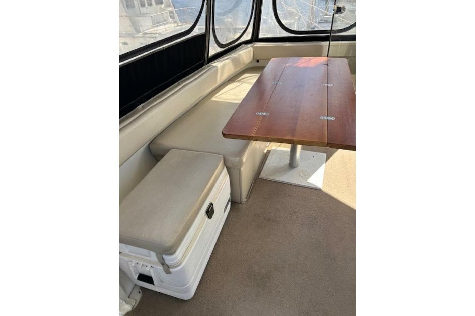 Interior of 2004 Carver 466 Motor Yacht with seating and wooden table.