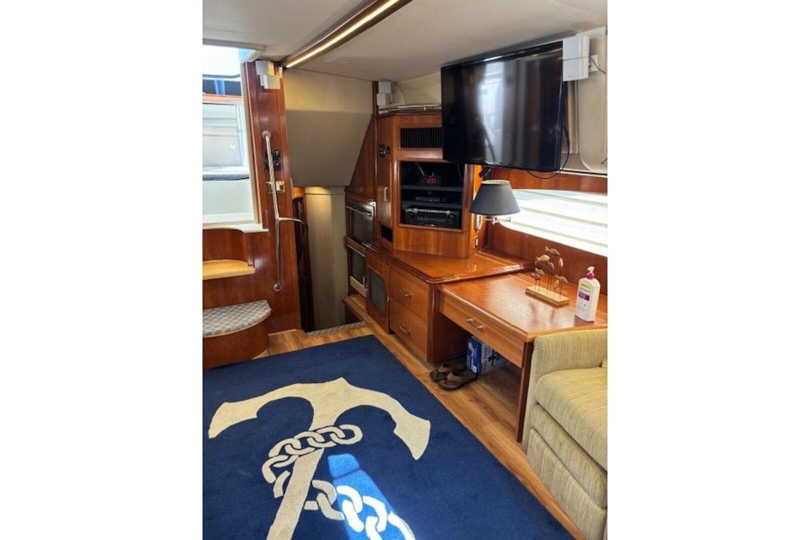 Luxurious interior of 2004 Carver 466 Motor Yacht with TV and nautical decor.