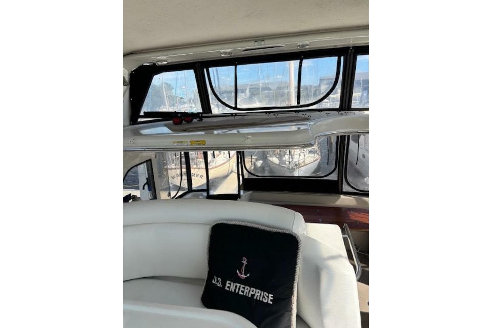 Interior of 2004 Carver 466 Motor Yacht with cushioned seating and large windows.