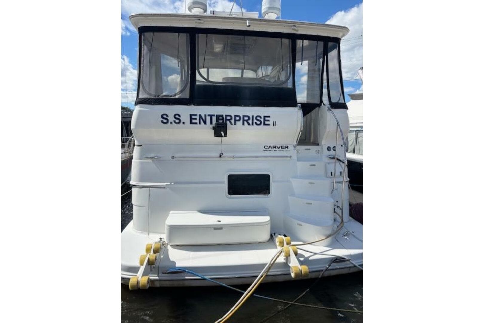 2004 Carver 466 Motor Yacht docked, named "S.S. Enterprise II," with visible rear view.