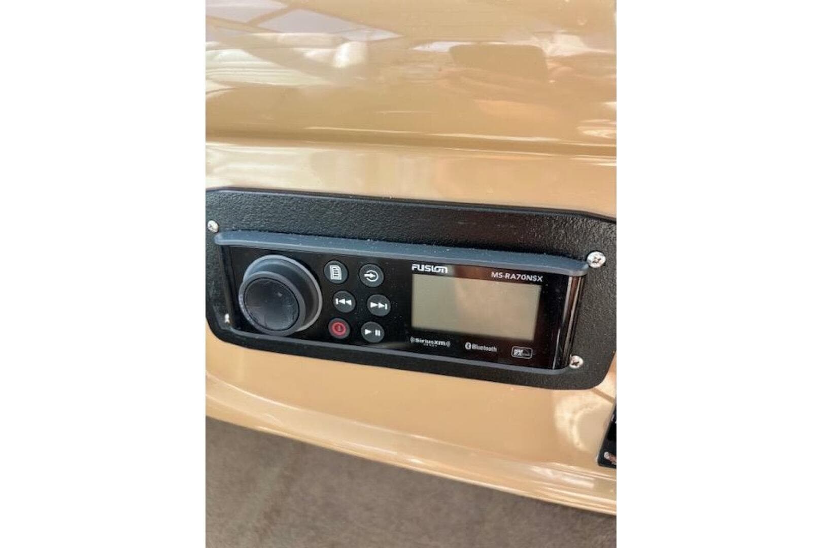 Control panel of a 2004 Carver 466 Motor Yacht with Fusion MS-RA70NSX stereo system.