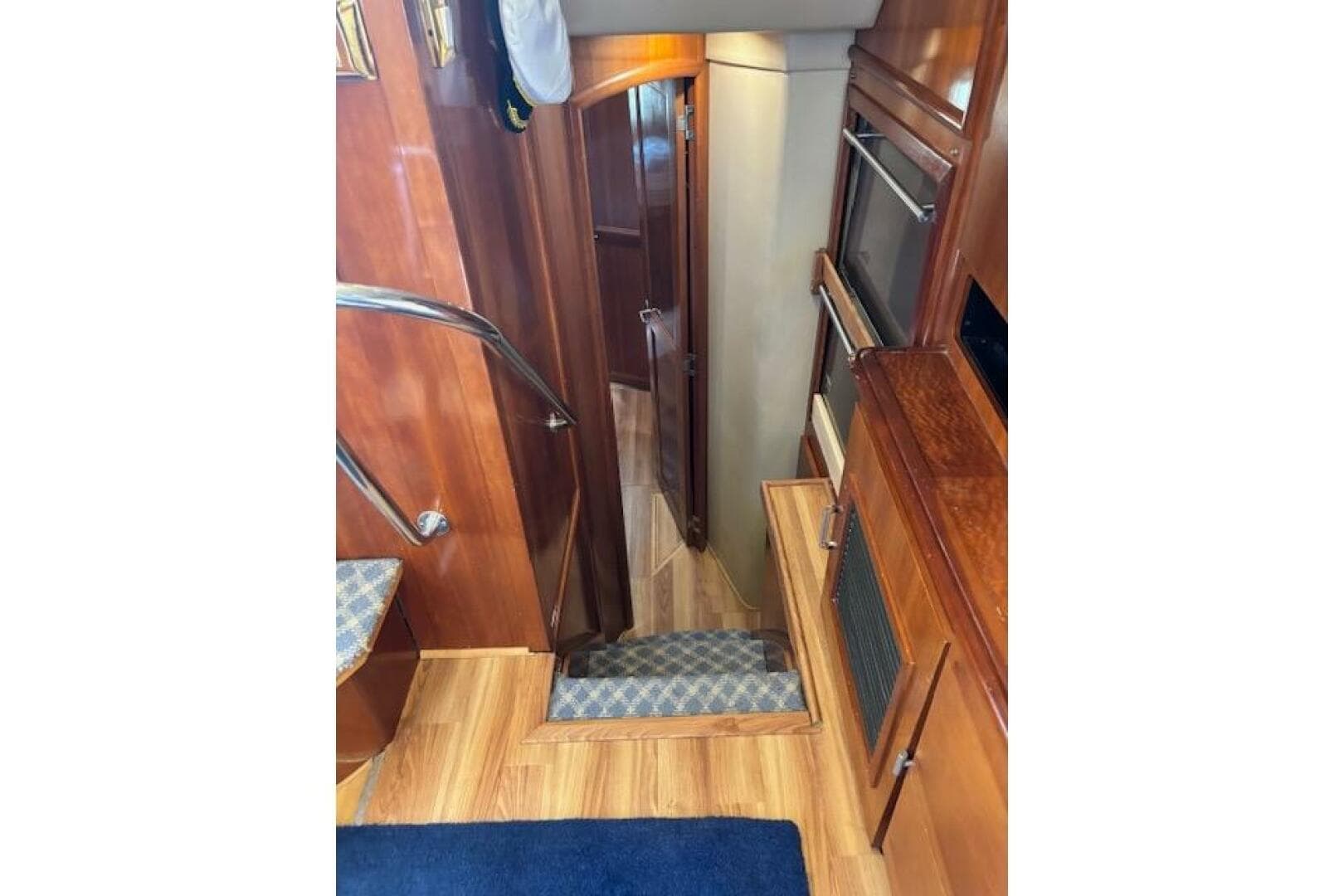 Interior of 2004 Carver 466 Motor Yacht with wooden stairs and cabinetry.