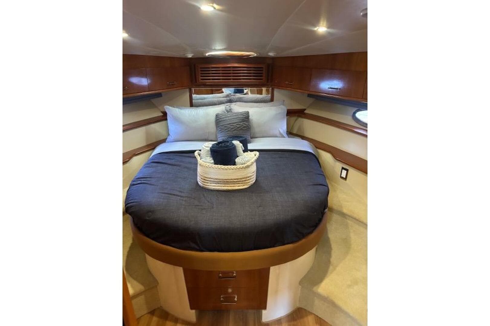 Luxurious bedroom interior of 2004 Carver 466 Motor Yacht with elegant bedding and wood accents.