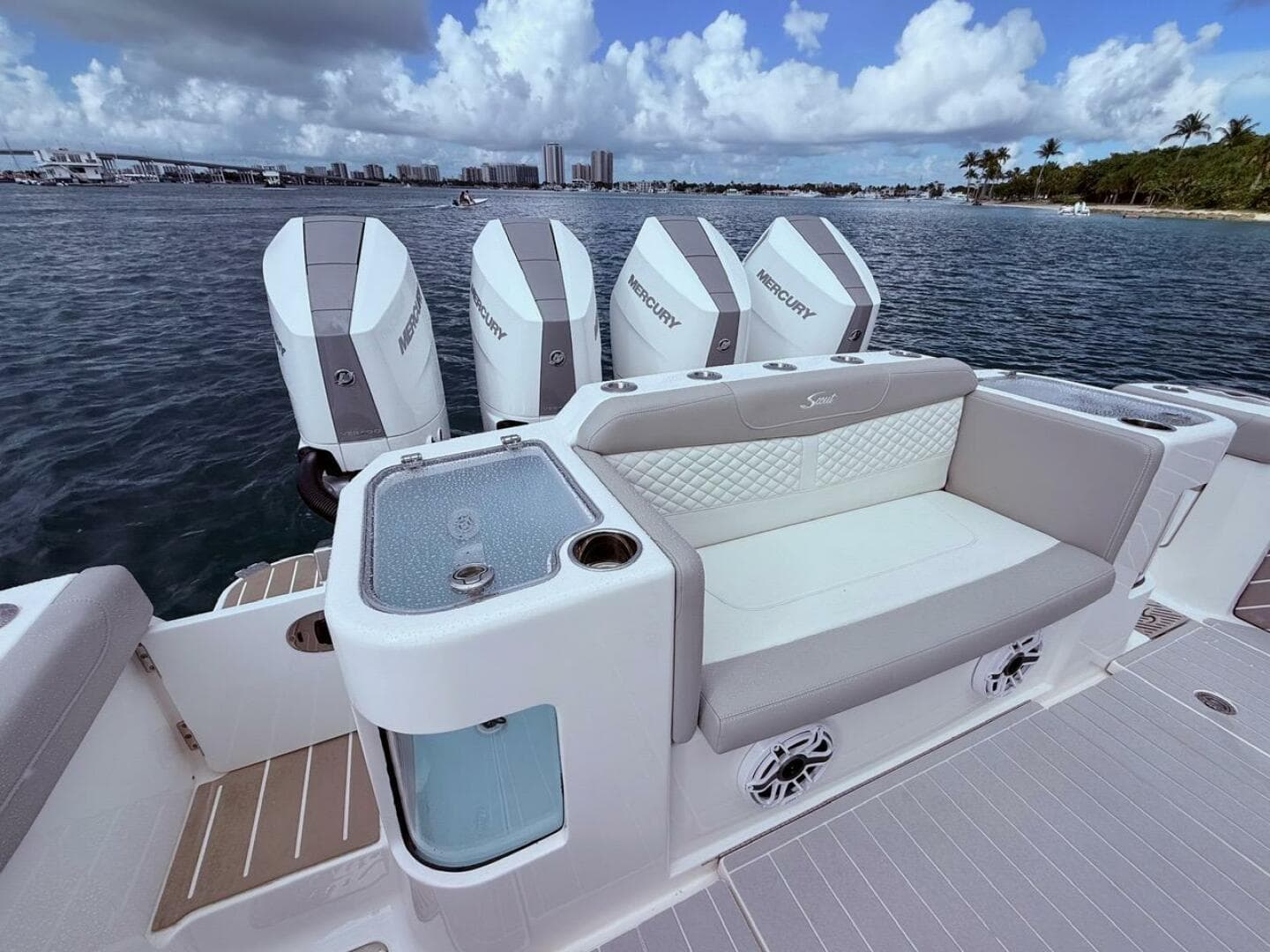 2024 Scout 400 LXF boat with Mercury engines, luxurious seating, and ocean view.