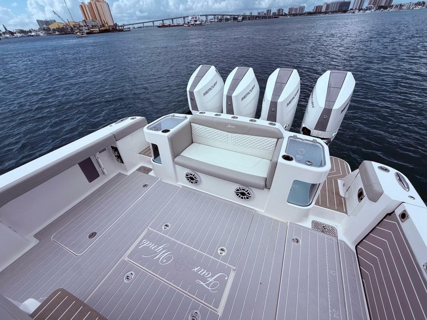 2024 Scout 400 LXF boat deck with seating and multiple Mercury engines.
