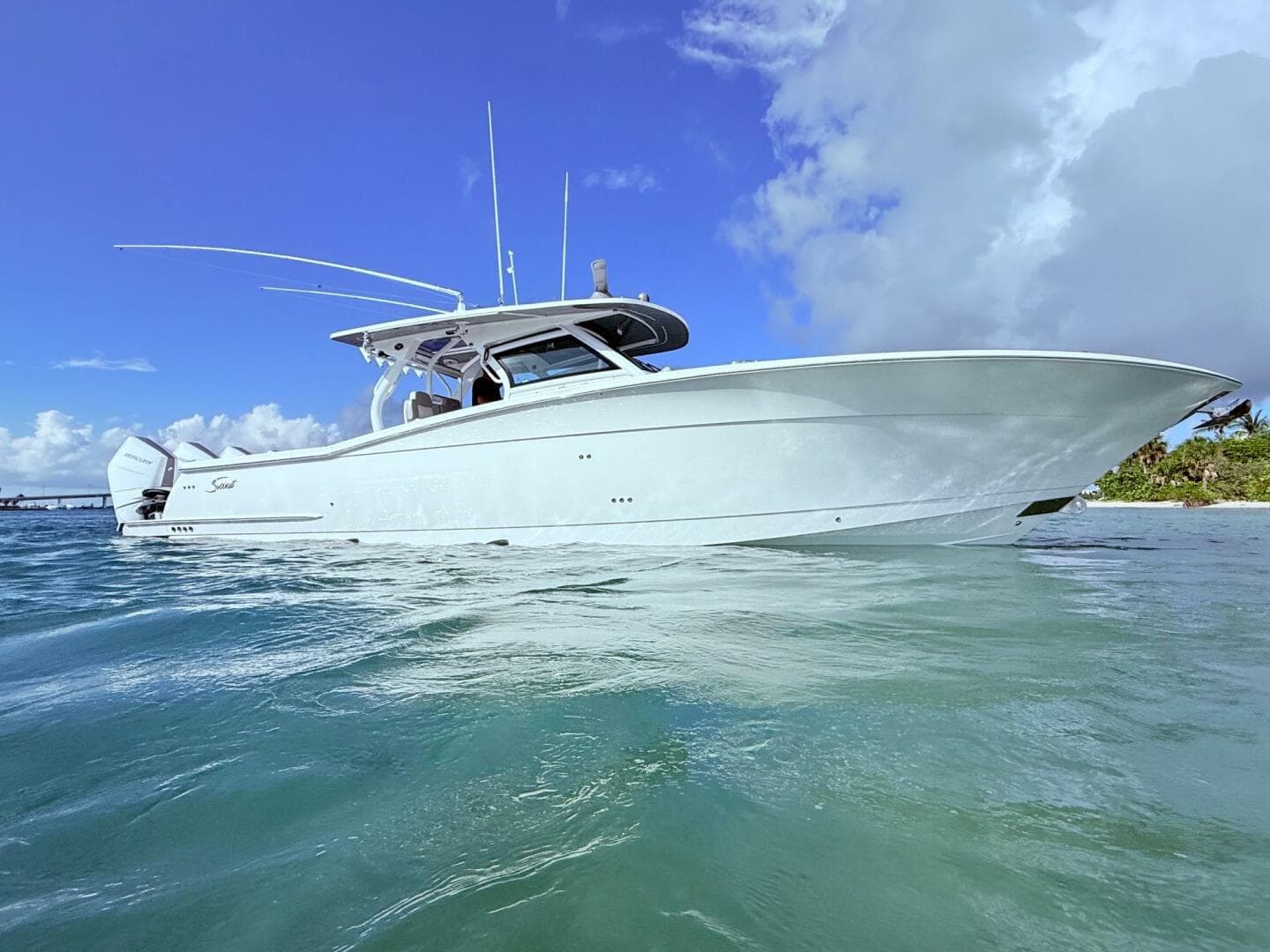 2024 Scout 400 LXF boat on clear blue water under a bright sky.