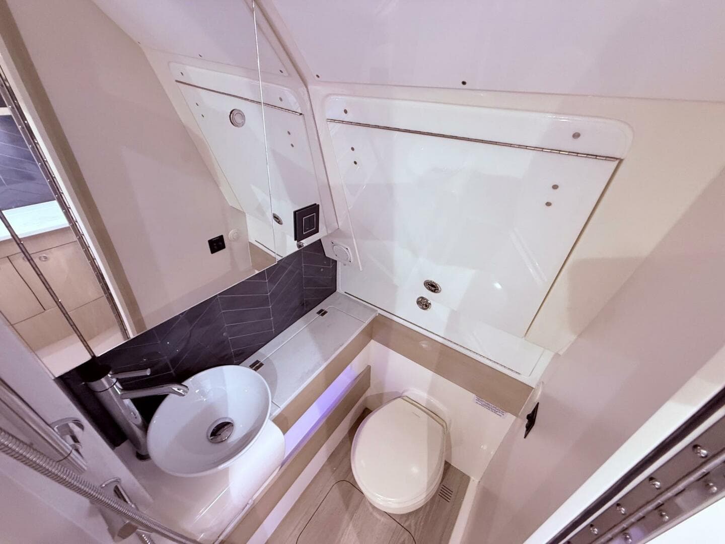 Luxurious bathroom interior of 2024 Scout 400 LXF boat, featuring modern sink and toilet.