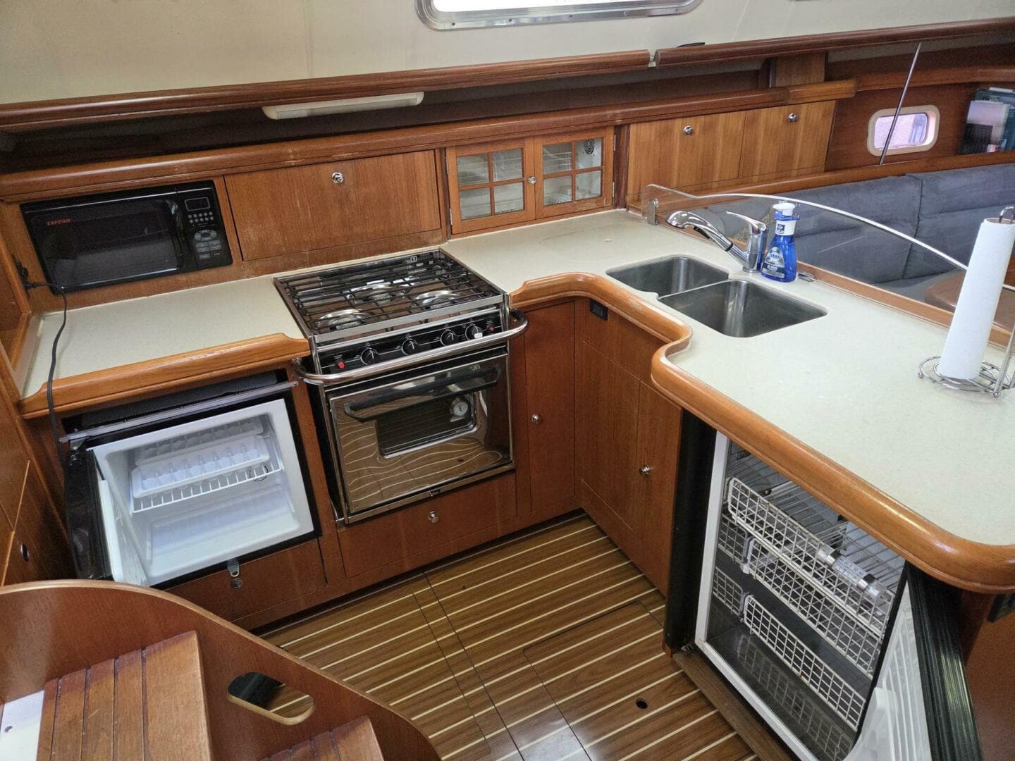 Galley with fridge, freezer, sink, propane cooktop/oven