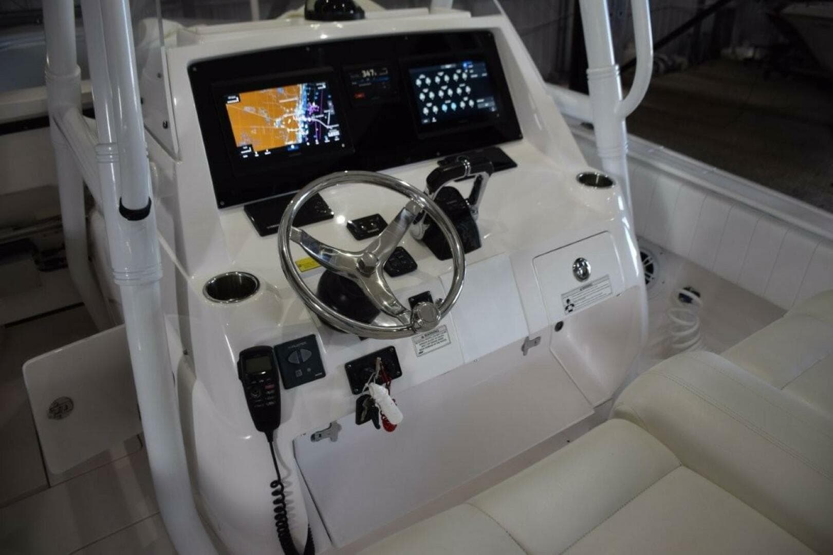 2017 Intrepid 327 Open Boat Dashboard With Steering Wheel And Navigation Screens.