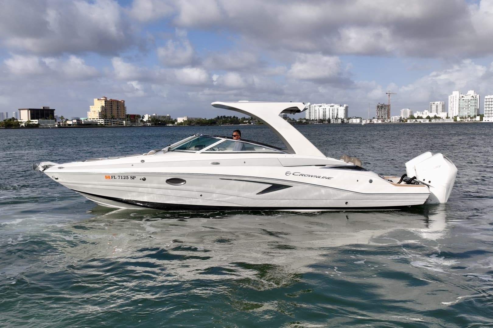 Crownline E305 XS powered by twin 225hp Mercury outboards. Spacious bow and cockpit seating, hardtop shade, swim platform, and onboard head. Ideal for cruising, sandbar stops, and watersports.