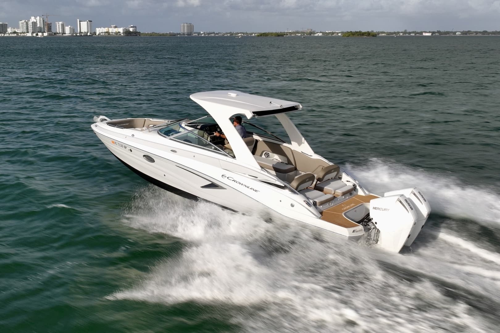 Crownline E305 XS powered by twin 225hp Mercury outboards. Spacious bow and cockpit seating, hardtop shade, swim platform, and onboard head. Ideal for cruising, sandbar stops, and watersports.