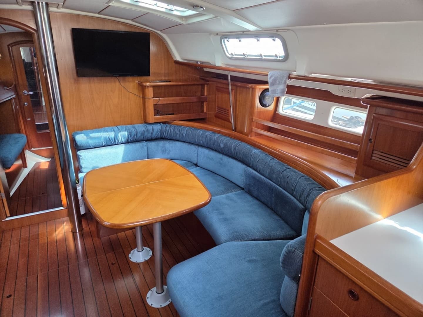 Interior of 2000 Beneteau Oceanis 411 yacht with blue cushions and table