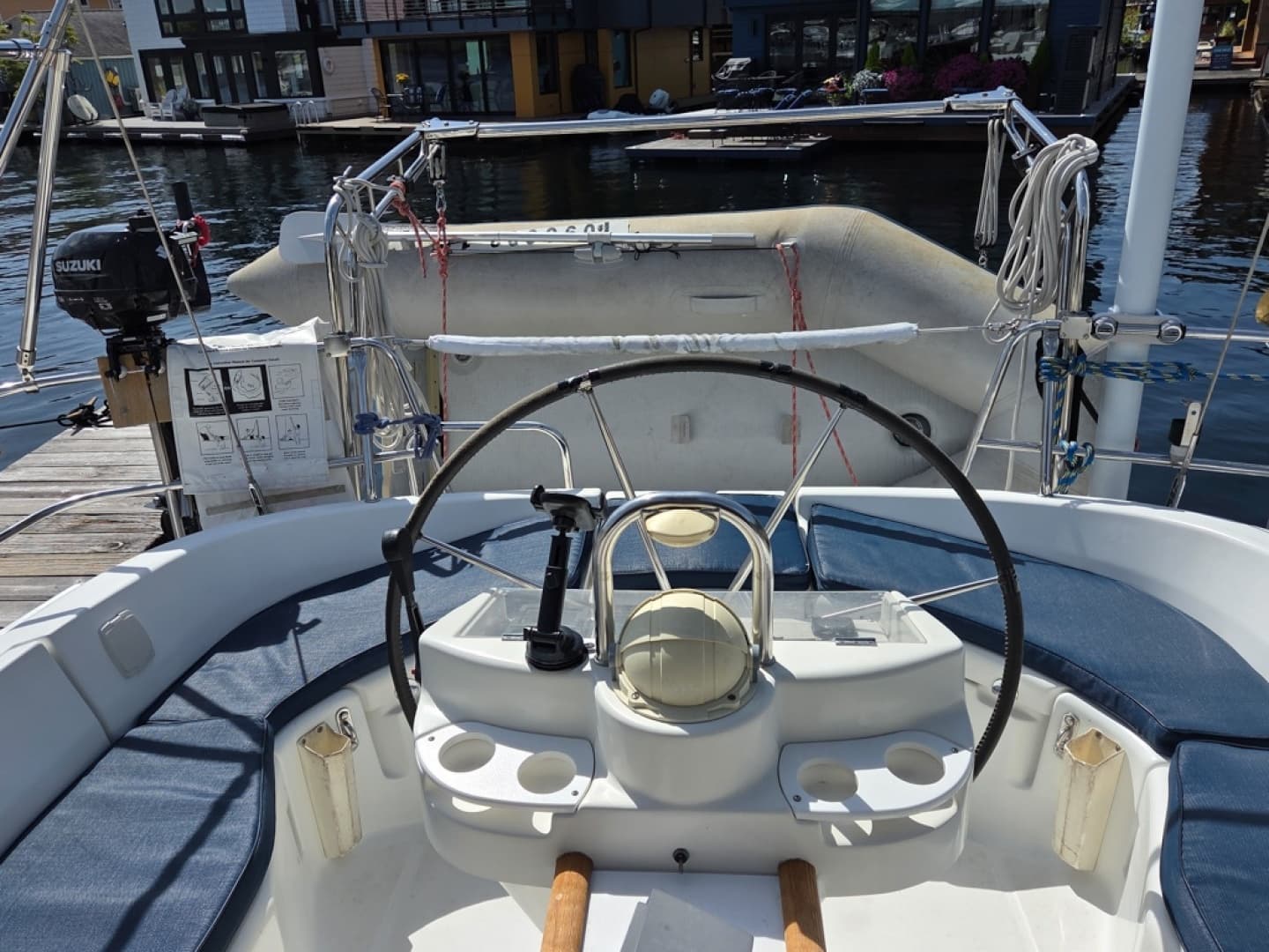 Cockpit of a 2000 Beneteau Oceanis 411 sailboat showing davits and dinghy